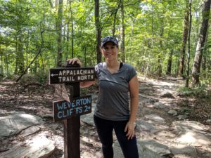Standing in front of an Appalachian Trail sign