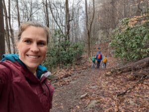 Hiking in the wood with family behind